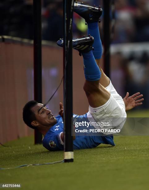 Cruz Azul's midfielder Rafael Baca falls during the Mexican Clausura tournament match against Atlas at the Azul stadium in Mexico City on February...