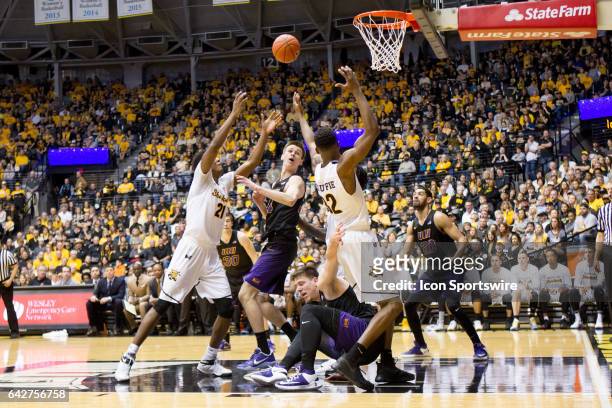 Scramble for a loose ball during the Missouri Valley Conference mens basketball game between the Northern Iowa Panthers and the Wichita State...