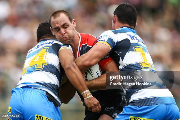 Simon Mannering of the Warriors is tackled by Pat Politoni and Morgan Boyle of the Titans during the NRL Trial match between the Warriors and the...
