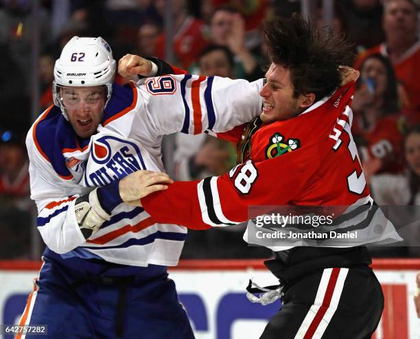 Ryan Hartman of the Chicago Blackhawks and Eric Gryba of the Edmonton Oilers fight in the second period at the United Center on February 18, 2017 in...