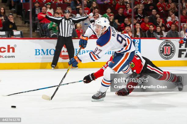 Connor McDavid of the Edmonton Oilers shoots the puck, resulting in an empty-net goal against the Chicago Blackhawks in the third period at the...