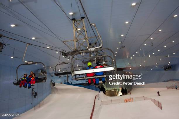 Visitors to the Mall of the Emirates indoor ski slope take the chair lift to the top. The Mall of the Emirates is a premier shopping mall in the Al...