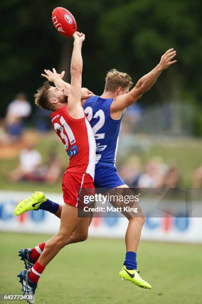 Mason Wood of the Kangaroos is challenged by Harry Marsh of the Swans during the 2017 JLT Community Series match between the Sydney Swans and North...