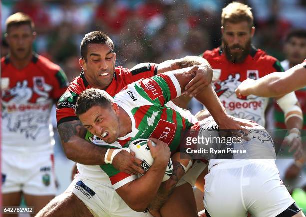 Sam Burgess of the Rabbitohs is tackled by Paul Vaughan of the Dragons during the NRL Charity Shield match between the South Sydney Rabbitohs and the...