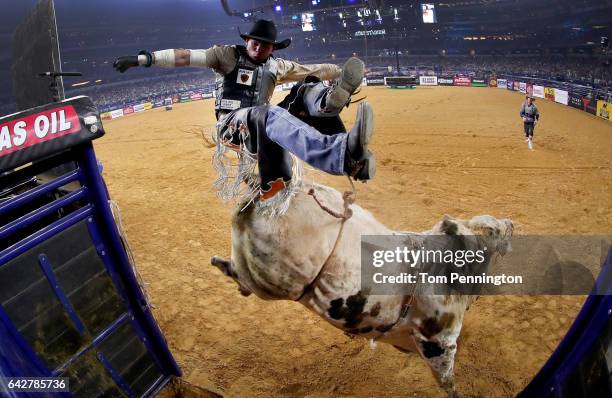 Marco Antonio Eguchi of Brazil gets bucked off of Bottoms Up in the first round of the PBR Frontier Communications Iron Cowboy at AT&T Stadium on...