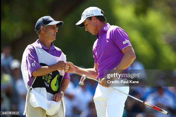 Brett Rumford of Australia celebrates with his caddie after a birdie putt on the shoot out hole in match seventeen of the match play during round...