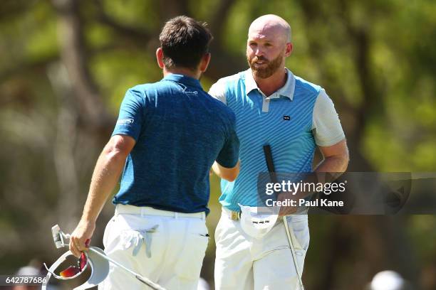 Adam Bland of Australia shakes hands with Louis Oosthuizen of South Africa after winning match eighteen of the match play during round four of the...