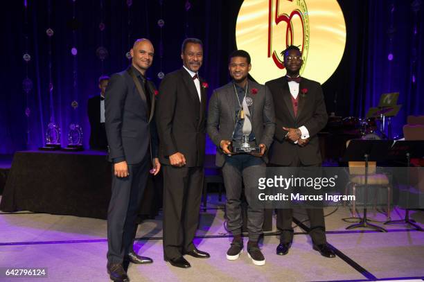 Dondre Whitfield, Morehouse President John Silvanus Wilson Jr., Usher Raymond, and Michael Claudius Adeyemi Saunders poses on stage during the...