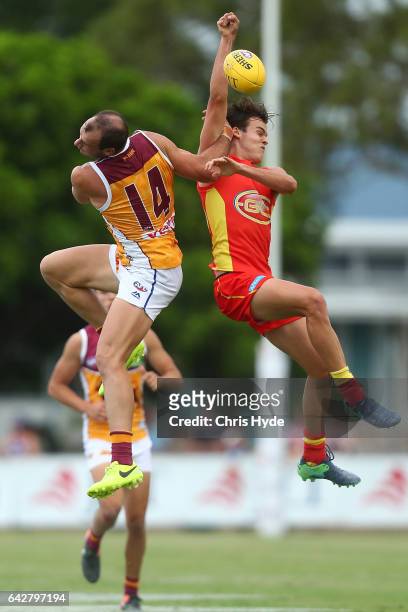 Josh Walker of the Lions and Jack Bowes of the Suns compete for the ball during the 2017 JLT Community Series match at Broadbeach Sports Centre on...