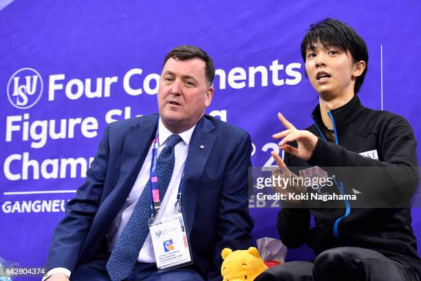 Yuzuru Hanyu of Japan talks with his coach Brian Orser at the podium in the men's free skating during ISU Four Continents Figure Skating...