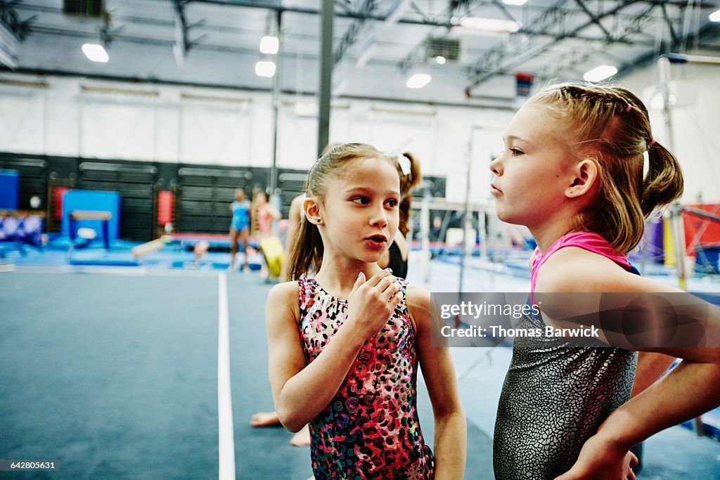 Female gymnasts waiting to perform floor routine