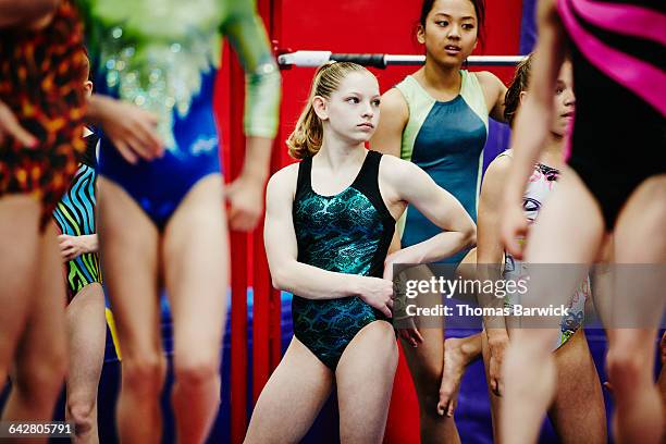 Female gymnast listening with group of teammates