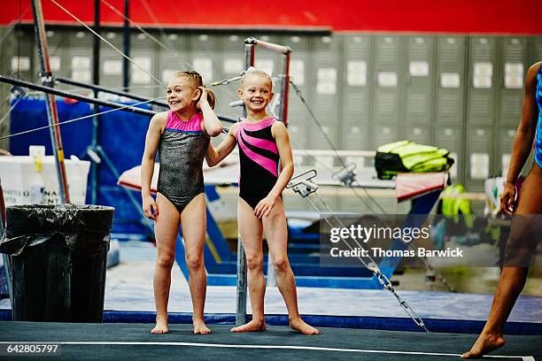 gymnasts watching teammates perform floor routine - daily sport girls bildbanksfoton och bilder