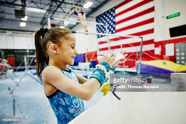 gymnast chalking hands before training session - sports chalk stock pictures, royalty-free photos & images
