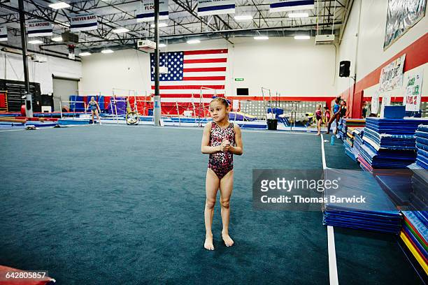 Gymnast waiting on floor during training session