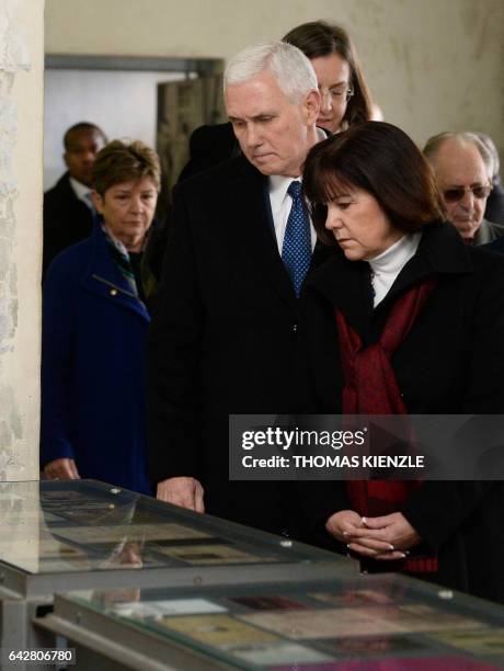 Vice President Michael Richard Pence and his wife Karen Pence look at exhibits during a visit of the former Nazi concentration camp of Dachau,...