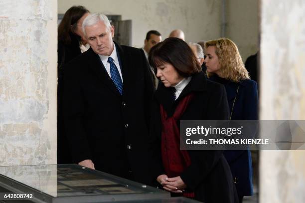 Vice President Michael Richard Pence and his wife Karen Pence look at exhibits during a visit of the former Nazi concentration camp of Dachau,...