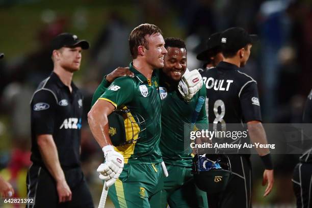 De Villiers of South Africa celebrates with teammate Andile Phehlukwayo after winning the First One Day International match between New Zealand and...