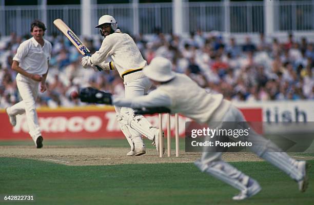 Sri Lankan batsman Ravi Ratnayeke puts a ball past England wicket-keeper Jack Russell off the bowling of Neil Foster , during a one day international...