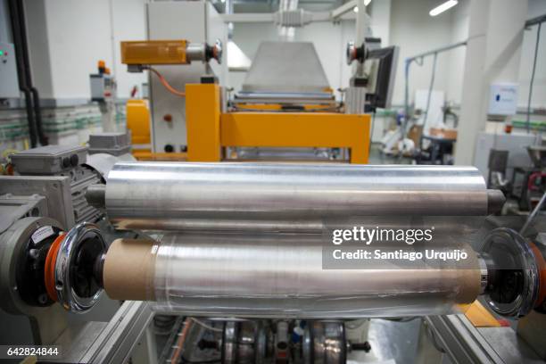 rolls of printed plastic film in food packaging printing factory - polyester stock pictures, royalty-free photos & images