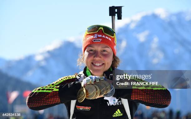Germany's Laura Dahlmeier poses with her six medals after winning the 2017 IBU World Championships Biathlon Women's 12,5 km Mass start race in...