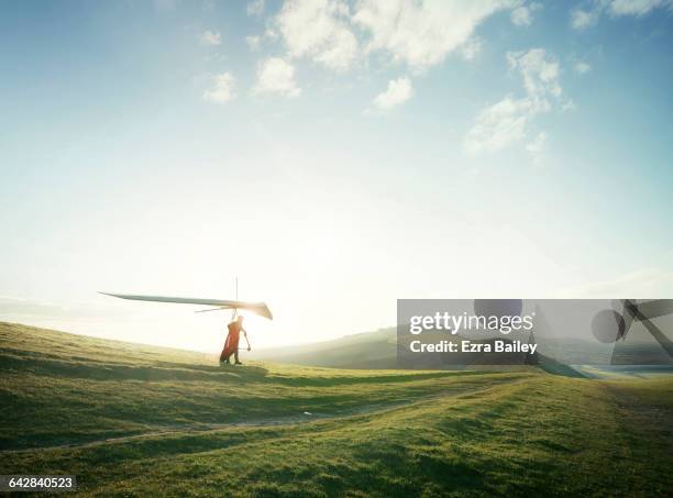 hang glider setting off from hill top. - discovery green stock pictures, royalty-free photos & images