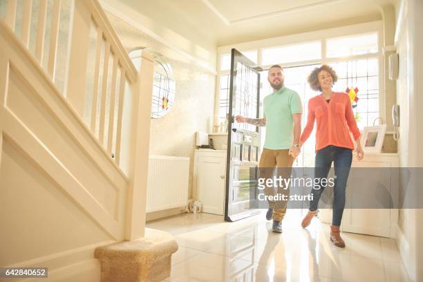 excited couple with keys to new home - entering stock pictures, royalty-free photos & images