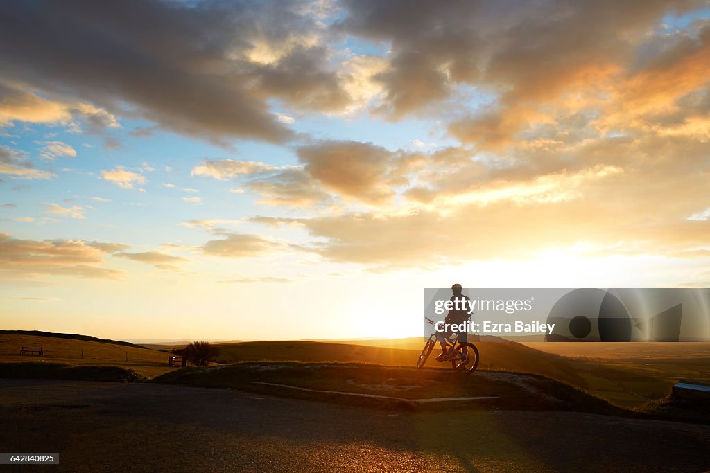 Mountain biker admiring the view from hilltop