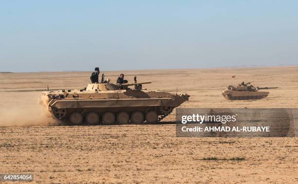 Tanks and armoured vehicles of the Iraqi forces, supported by the Hashed al-Shaabi paramilitaries, advance towards the village of Sheikh Younis,...