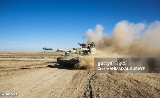 Tanks and armoured vehicles of the Iraqi forces, supported by the Hashed al-Shaabi paramilitaries, advance towards the village of Sheikh Younis,...