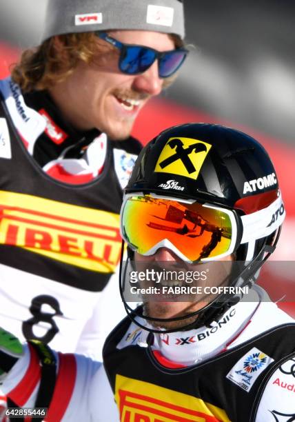 Second-placed Austria's Manuel Feller and winner Austria's Marcel Hirscher celebrate after the second run of the men's slalom race at the 2017 FIS...