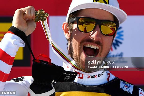 Austria's Marcel Hirscher celebrates with his gold medal on the podium of the men's slalom race at the 2017 FIS Alpine World Ski Championships in St...