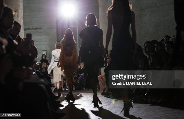 Models present creations during the catwalk show of France's Roland Mouret on the third day of the Autumn/Winter 2017 London Fashion Week at the...