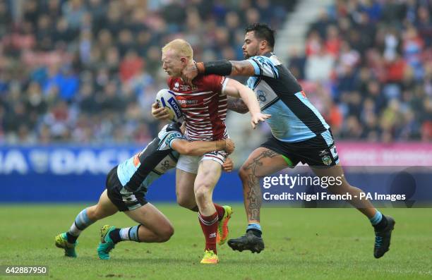 Wigan Warriors' Liam Farrell is tackled by Cronulla-Sutherland Sharks' Jayden Brailey during the 2017 Dacia World Club Series match at the DW...