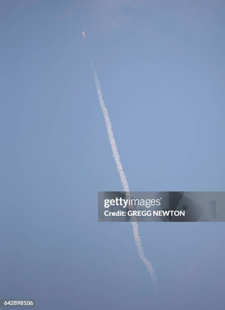 The SpaceX Falcon 9 rocket, carrying a Dragon cargo capsule, is seen from Port Canaveral, Florida, as it launches from the Kennedy Space Center...