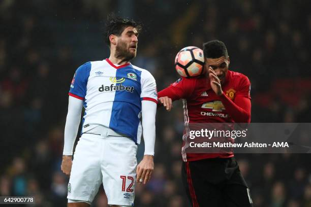 Danny Graham of Blackburn Rovers competes with Chris Smalling of Manchester United during the Emirates FA Cup Fifth Round match between Blackburn...