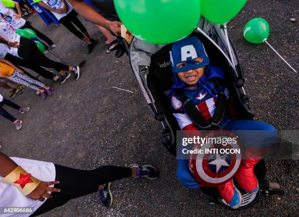 Boy dressed as "Capitan America" rests in his stroller during the "5K Heroes with True Battles" in support of children with cancer, in Managua on...