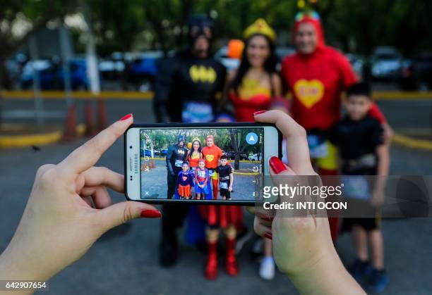 People taking part in the "5K Heroes with True Battles" in support of children with cancer pose for pictures in Managua on February 19, 2017. People...