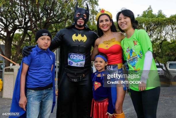 People taking part in the "5K Heroes with True Battles" in support of children with cancer pose for pictures in Managua on February 19, 2017. People...