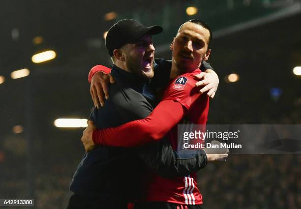 Zlatan Ibrahimovic of Manchester United celebrates with a fans as he runs onto the pitch as he scores their second goal during The Emirates FA Cup...