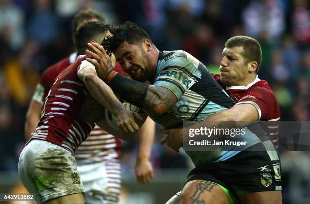 Andrew Fifita of Cronulla-Sutherland Sharks is tackled by Tony Clubb and Morgan Escare of Wigan Warriors during the Dacia World Club Challenge match...