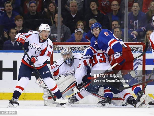 Nate Schmidt Philipp Grubauer and Jay Beagle of the Washington Capitals defend against Mika Zibanejad of the New York Rangers during the first period...