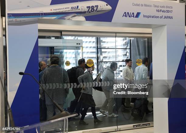 The first passengers arrive from a All Nippon Airways Co. Flight during the company's media event at Benito Juarez International Airport in Mexico...