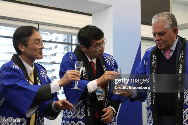 Akira Yamada, Japan's ambassador to Mexico, center, and Hideshi Oshimo, general manager of Mexico operations for All Nippon Airways Co. , left, toast...