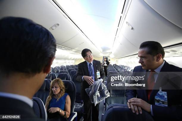 Hideki Kunugi, senior vice president of the Americas at All Nippon Airways Co. , center, speaks with attendees inside the company's Boeing Co. 787-8...