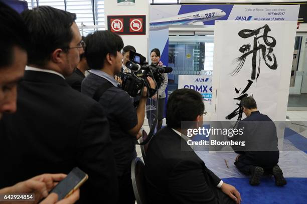 Japanese calligraphy artist paints during an All Nippon Airways Co. Media event at Benito Juarez International Airport in Mexico City, Mexico on...