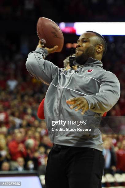 James White, running back for the New England Patriots and former Wisconsin football player, throws an autographed football into the stands during a...