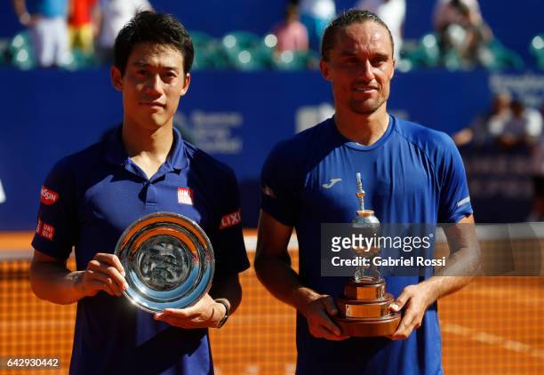 Kei Nishikori of Japan and Alexandr Dolgopolov of Ukraine pose with the trophy after finish the final match between Kei Nishikori of Japan and...