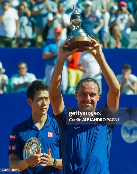 Ukraine's tennis player Alexandr Dolgopolov poses with his trophy after defeating Japan's Kei Nishikori in the final of the Argentina Open at the...
