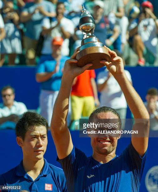 Ukraine's tennis player Alexandr Dolgopolov poses with his trophy after defeating Japan's Kei Nishikori in the final of the Argentina Open at the...